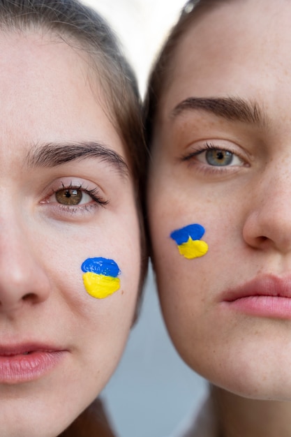 Free Photo women with ukrainian flags paint close up