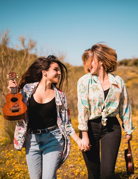 Women with ukuleles looking at each other