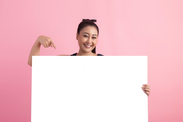 women with white empty board, pointing away