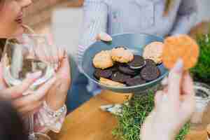 Free photo women with wine eating cookies