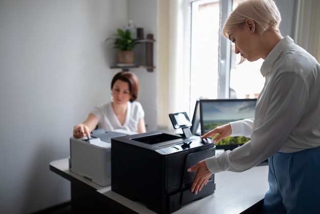 Women at work in the office using printer