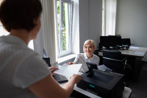 Women at work in the office using printer