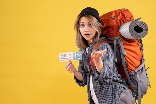 Free photo wondered traveler woman with backpack holding ticket