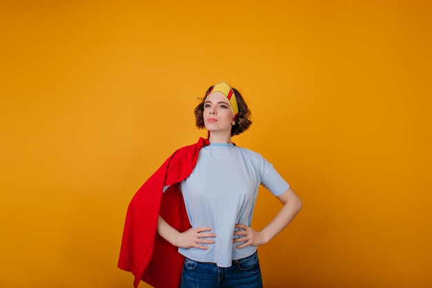 Free photo wonderful female hero in trendy attire posing on yellow space