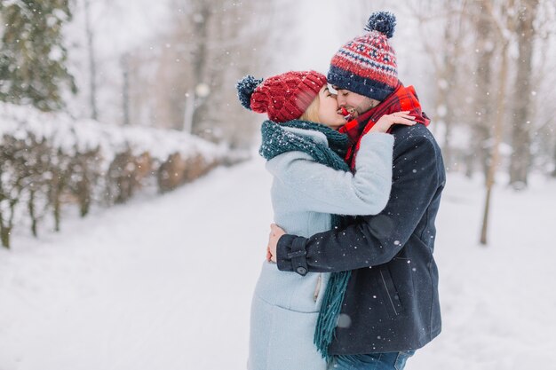 Wonderful kissing couple in snowflakes