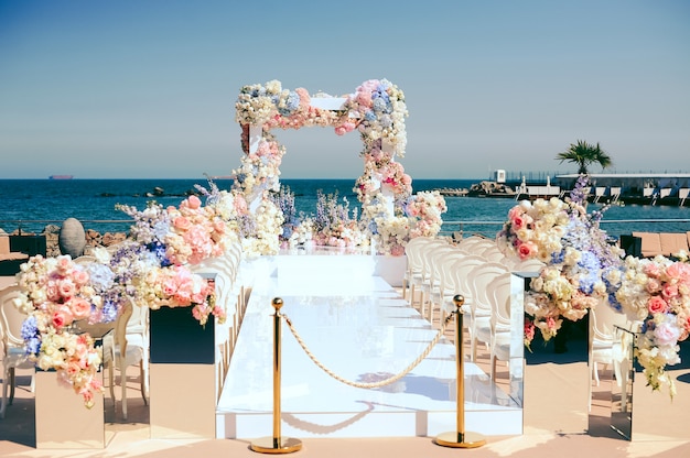 wonderful wedding ceremony place near the sea decorated by flowers