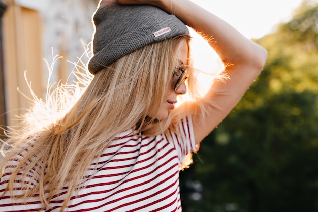 Wonderful woman posing outdoor holding gray hat