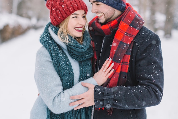 Free photo wonderful young couple in snowfall