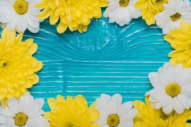 Wooden background with flowers frame