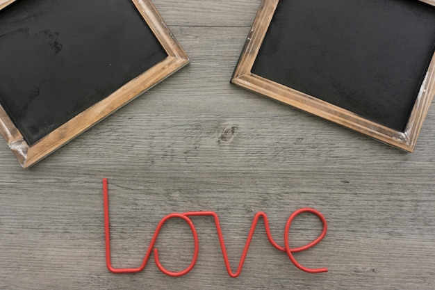 Wooden background with slates and word love