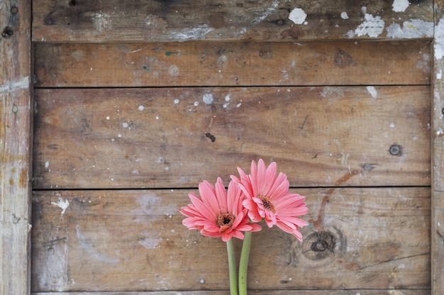 Free photo wooden background with stains and decorative flowers