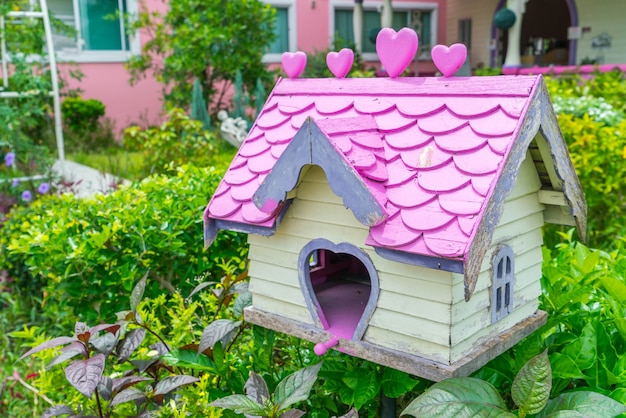 Wooden bird house in park .