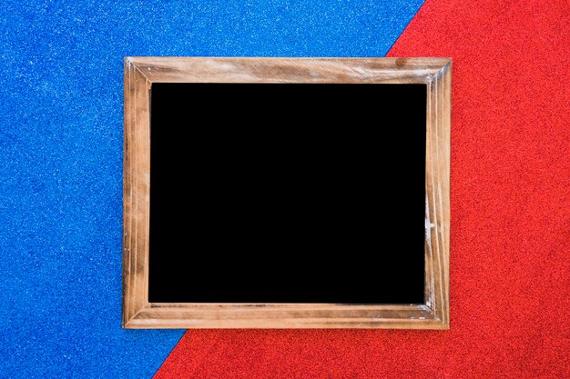 Wooden blank slate on dual blue and red backdrop