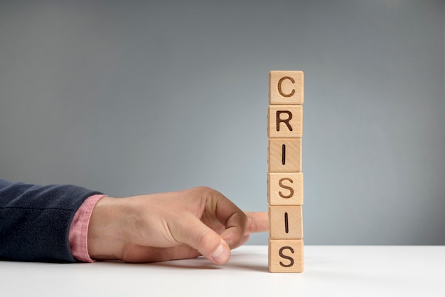 Free photo wooden blocks with crisis mesage