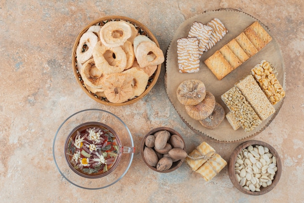 Free Photo a wooden board full of sweet cookies and cup of herbal tea