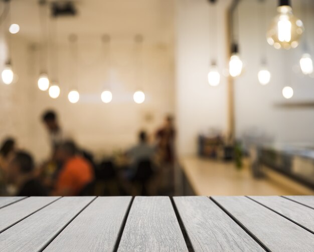 Wooden board looking out to blurred restaurant scene