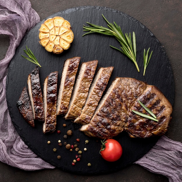 Wooden board with cooked meat