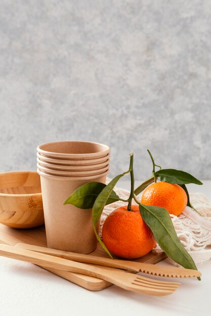 Wooden board with cutlery and mandarins