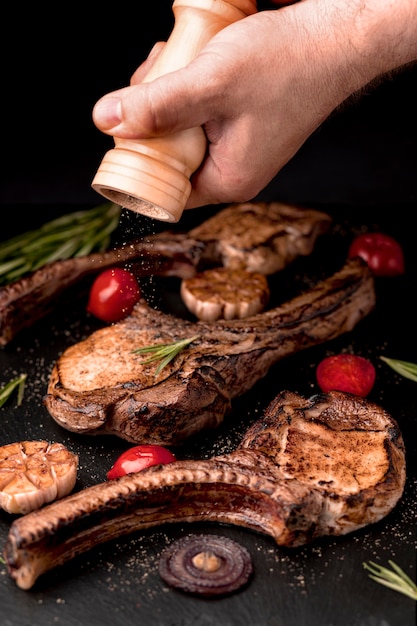 Free photo wooden board with delicious cooked meat