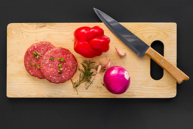 Free photo wooden board with hamburger ingredients