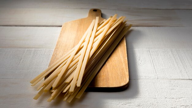 Wooden board with spaghetti