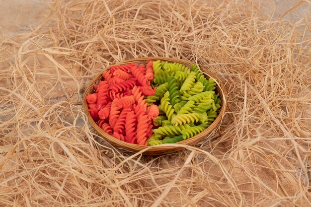 A wooden bowl full of bow tie pasta on marble background. High quality photo