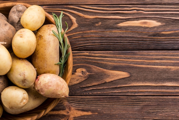 Wooden bowl with potatoes