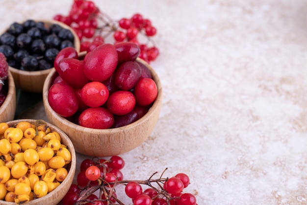 Free Photo a wooden bowls full of delicious berries .