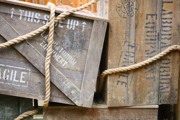 Free photo wooden box with text written on them and ropes around them