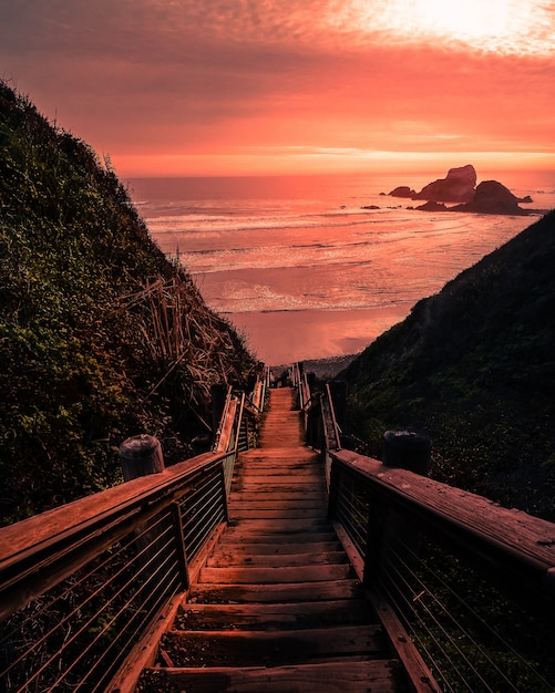 wooden bridge to the beach during sunset