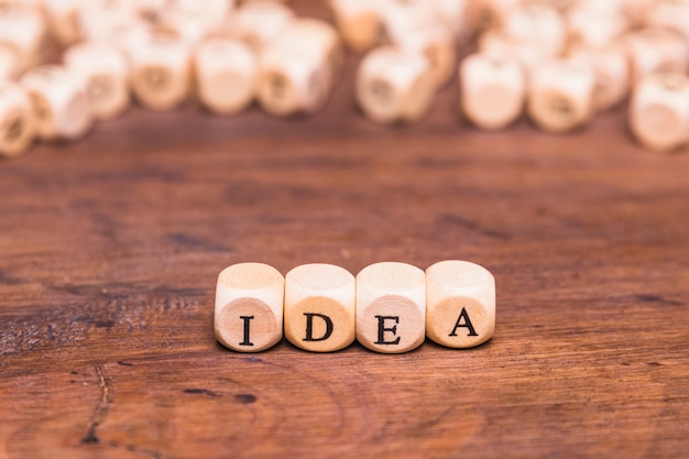 Wooden cubes with letter idea over desk