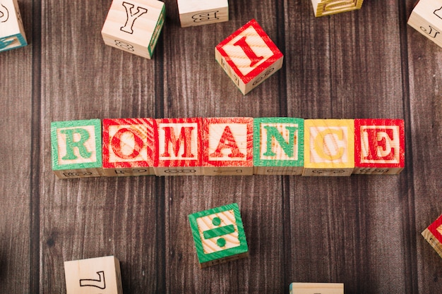 Free photo wooden cubes with romance title