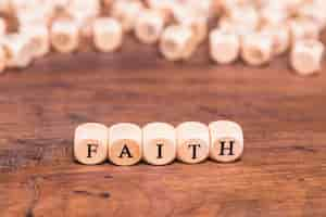 Free photo wooden cubes with word faith on table