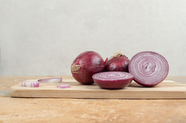 A wooden cutting board with sliced onion