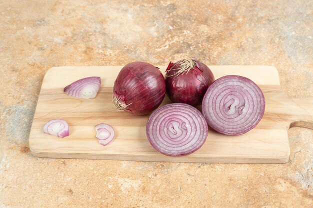 A wooden cutting board with sliced onion