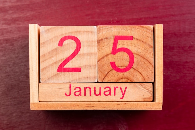 Free photo wooden date for chinese new year on red background