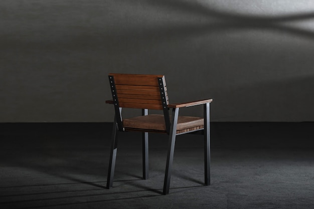 Free Photo wooden dining room chair in a studio with gray walls