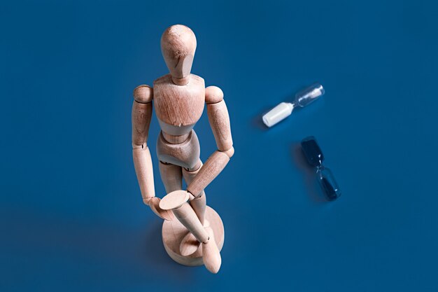 The wooden figurine on a blue surface