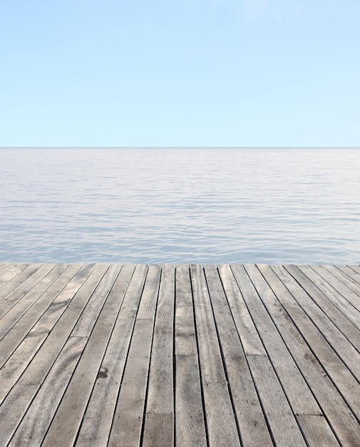 wooden floor and blue sea with waves and clear blue sky