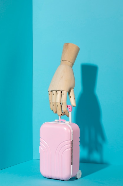 Wooden hand with luggage