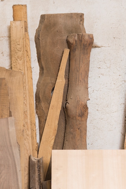 Free photo wooden log; plank and blocks against wall