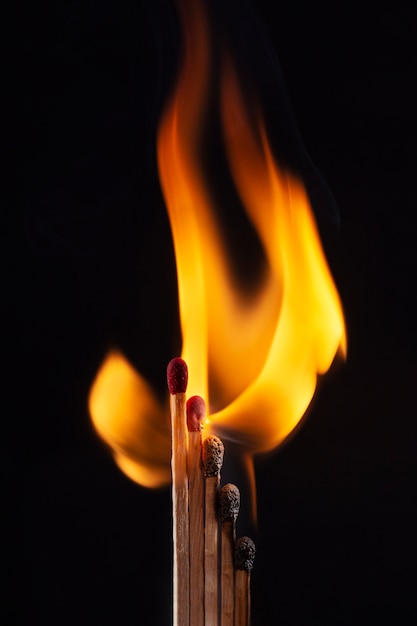 Wooden matches burning with dark background