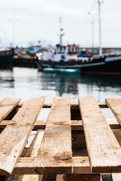 Free photo wooden pallets in a fishing boat harbor