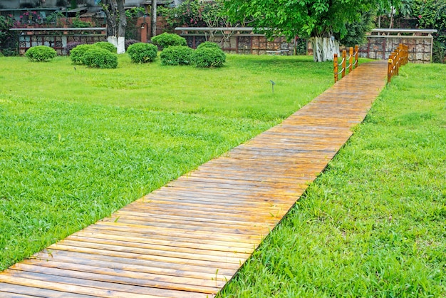 Wooden path and green grass