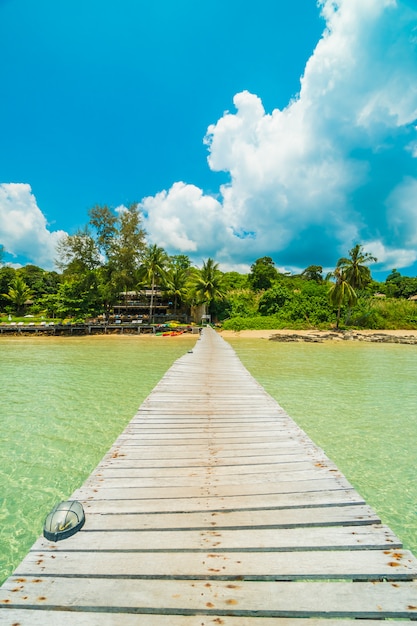 Wooden pier or bridge with tropical beach 