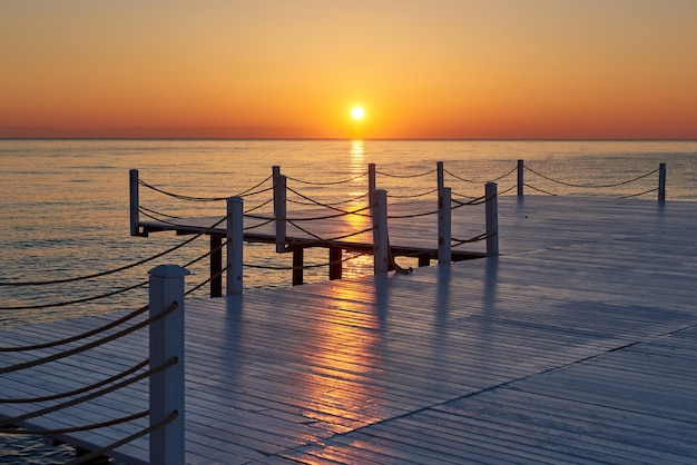 Free Photo wooden pier on a fancy orange sunset.