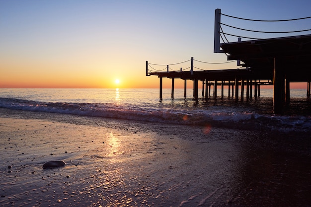 Free Photo wooden pier on a fancy orange sunset.