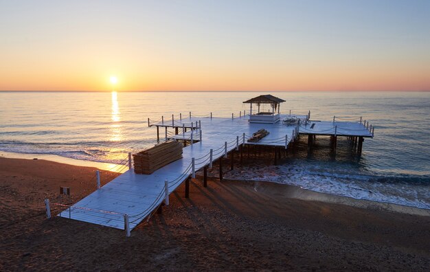 Wooden pier on a fancy orange sunset.