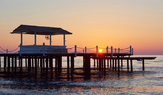 Wooden pier on a fancy orange sunset.