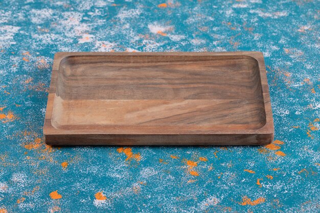 Wooden platter isolated on textured background